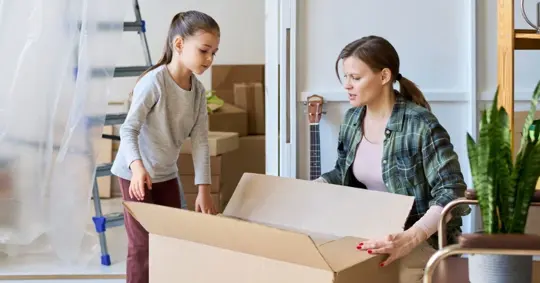 mother and daughter packing their house