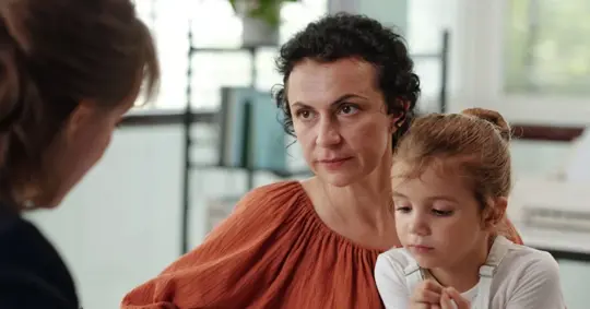 mother with daughter talking to a lawyer